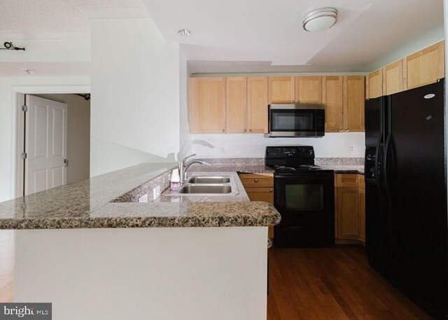 777 7th St NW Unit 913, Washington, DC 20001 - kitchen featuring black appliances, a sink, dark wood-style floors, light brown cabinetry, and a peninsula