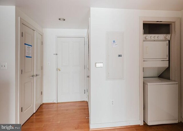 777 7th St NW Unit 913, Washington, DC 20001 - laundry area with stacked washer / dryer, electric panel, and light wood-type flooring