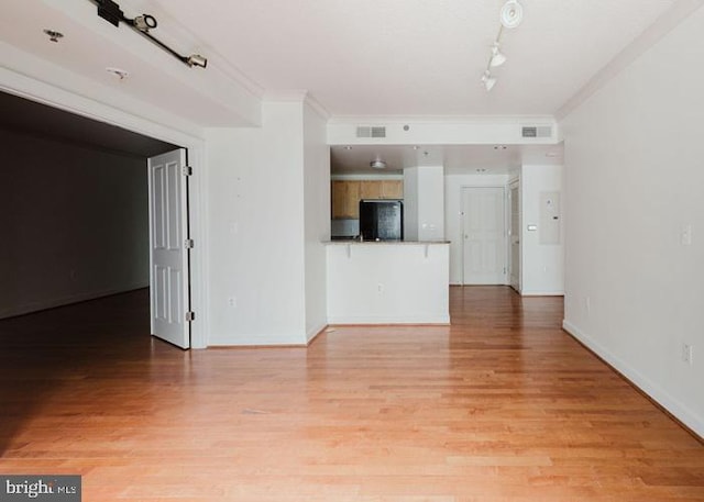 777 7th St NW Unit 913, Washington, DC 20001 - unfurnished living room featuring ornamental molding, track lighting, light wood-style flooring, and baseboards