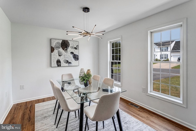 9509 Lincoln Ave, Manassas, VA 20110 - dining room with wood finished floors, baseboards, plenty of natural light, and a chandelier