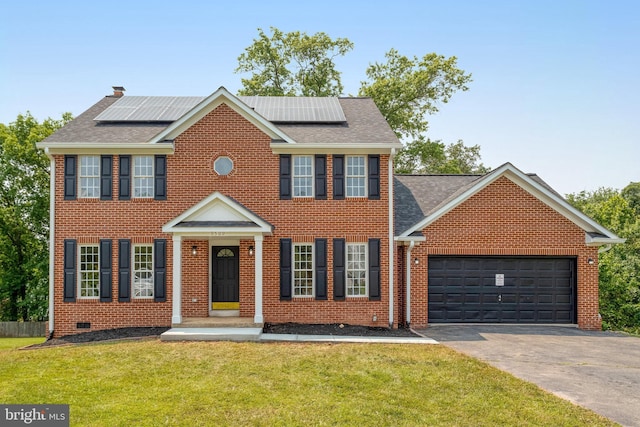9509 Lincoln Ave, Manassas, VA 20110 - colonial home featuring a front yard, asphalt driveway, an attached garage, and brick siding