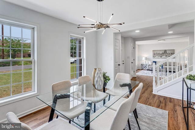 9509 Lincoln Ave, Manassas, VA 20110 - dining area with a chandelier, wood finished floors, baseboards, recessed lighting, and stairs