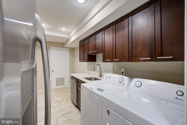 10249 Prince Pl Unit 31-203, Upper Marlboro, MD 20774 - laundry room featuring washing machine and clothes dryer, cabinet space, and recessed lighting