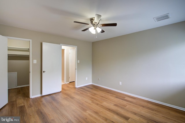 10249 Prince Pl Unit 31-203, Upper Marlboro, MD 20774 - unfurnished bedroom with a spacious closet, baseboards, light wood finished floors, and ceiling fan