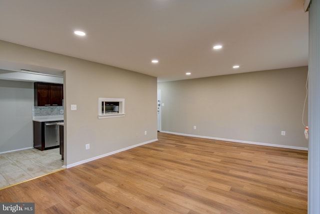 10249 Prince Pl Unit 31-203, Upper Marlboro, MD 20774 - unfurnished living room with light wood finished floors, recessed lighting, and baseboards
