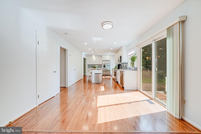 1434 Cellar Creek Way, Herndon, VA 20170 - kitchen with stainless steel appliances, light wood-style floors, white cabinetry, light countertops, and a kitchen island