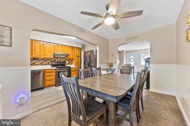 1518 Becklow Ave, Baltimore, MD 21220 - dining space with arched walkways, a ceiling fan, light carpet, and baseboards