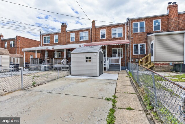 1518 Becklow Ave, Baltimore, MD 21220 - view of front of home with brick siding, a fenced backyard, and central AC