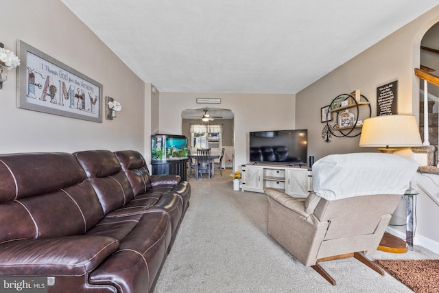 1518 Becklow Ave, Baltimore, MD 21220 - carpeted living room featuring a ceiling fan, arched walkways, and stairs