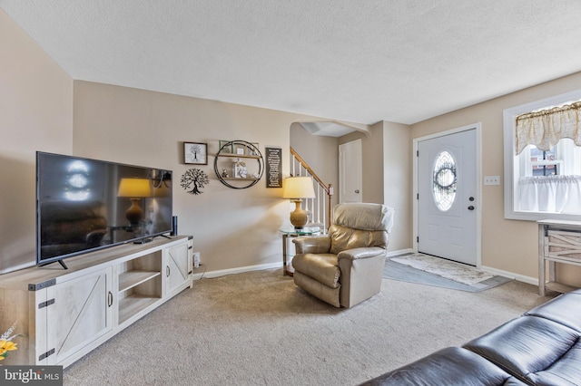1518 Becklow Ave, Baltimore, MD 21220 - living area featuring light carpet, arched walkways, a textured ceiling, baseboards, and stairway