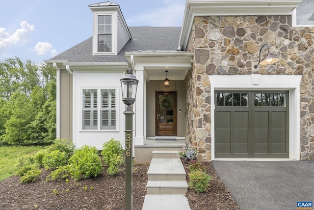 336 Avondale Ln, Crozet, VA 22932 - doorway to property featuring roof with shingles, driveway, stone siding, and a garage