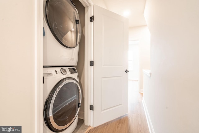 4096 Conshohocken Ave Unit A2, Philadelphia, PA 19131 - laundry room featuring stacked washing machine and dryer, light wood-style floors, and baseboards