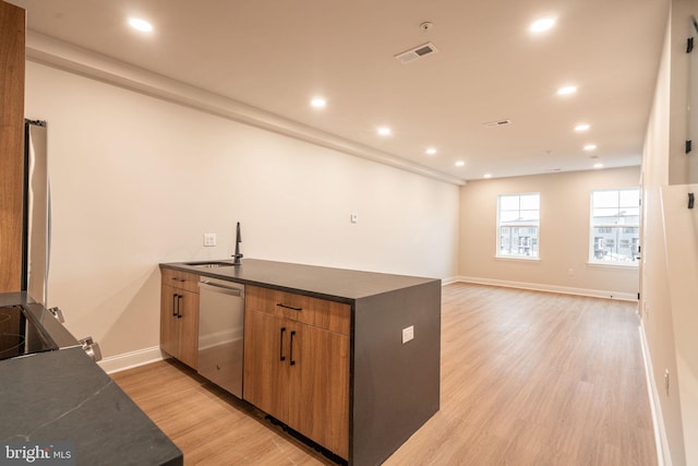 4096 Conshohocken Ave Unit A2, Philadelphia, PA 19131 - kitchen featuring dark countertops, dishwasher, a peninsula, light wood finished floors, and a sink