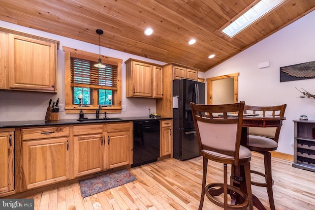 2733 Wood Ln, Morgantown, PA 19543 - kitchen with black appliances, a sink, vaulted ceiling, dark countertops, and light wood-style flooring