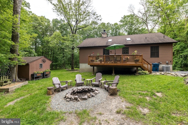 2733 Wood Ln, Morgantown, PA 19543 - rear view of property with an outdoor fire pit, a deck, a lawn, central AC unit, and a chimney