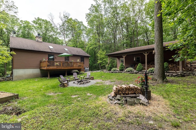2733 Wood Ln, Morgantown, PA 19543 - view of grassy yard featuring an outdoor fire pit and a wooden deck