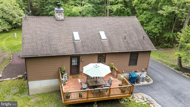 2733 Wood Ln, Morgantown, PA 19543 - back of house featuring cooling unit, a shingled roof, and outdoor dining space