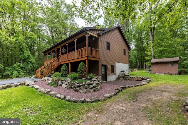 2733 Wood Ln, Morgantown, PA 19543 - view of front facade featuring a front yard, stairs, a deck, and asphalt driveway