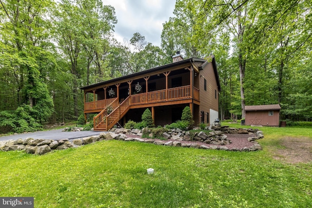 2733 Wood Ln, Morgantown, PA 19543 - view of front of house with stairs, a front yard, a chimney, and a deck