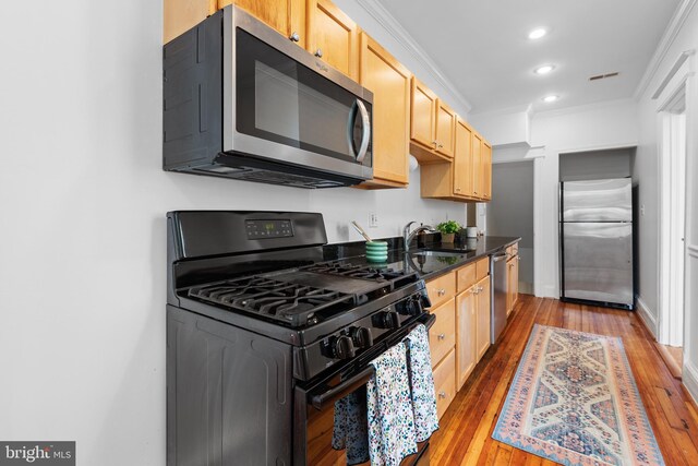 4022 Illinois Ave NW, Washington, DC 20011 - kitchen with appliances with stainless steel finishes, a sink, light brown cabinetry, light wood-style flooring, and crown molding