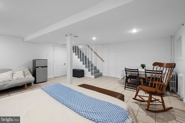 4022 Illinois Ave NW, Washington, DC 20011 - bedroom with freestanding refrigerator, light tile patterned flooring, and baseboards
