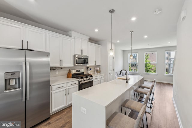 2510 Crimson Fox Dr, Hyattsville, MD 20782 - kitchen with appliances with stainless steel finishes, a sink, an island with sink, white cabinetry, and recessed lighting