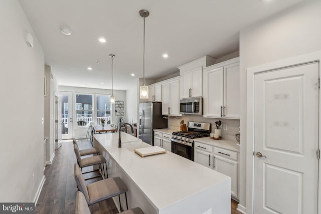 2510 Crimson Fox Dr, Hyattsville, MD 20782 - kitchen featuring stainless steel appliances, a kitchen island with sink, white cabinets, dark wood-style floors, and recessed lighting