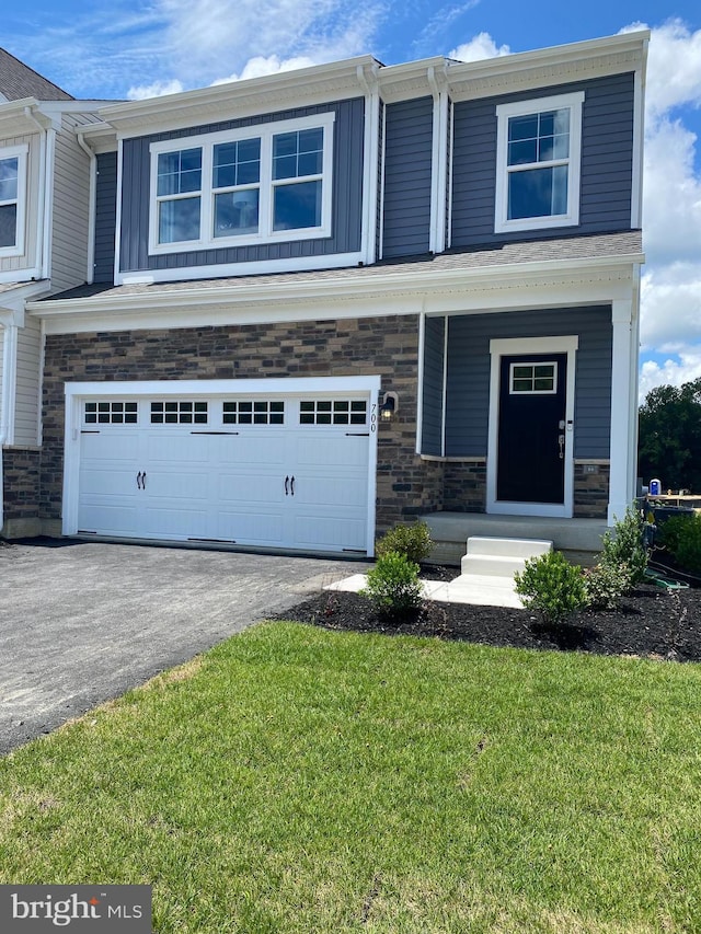 730 Aldora Dr Unit 114, Aberdeen, MD 21001 - view of front of property featuring a garage, a front yard, asphalt driveway, and stone siding