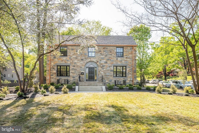 6040 Nebraska Ave NW, Washington, DC 20015 - view of front facade featuring a front lawn, stone siding, and roof with shingles