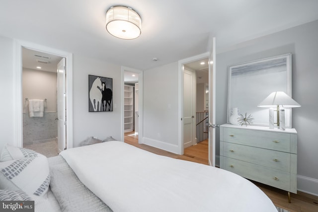 6040 Nebraska Ave NW, Washington, DC 20015 - bedroom featuring light wood finished floors, baseboards, a spacious closet, and ensuite bathroom