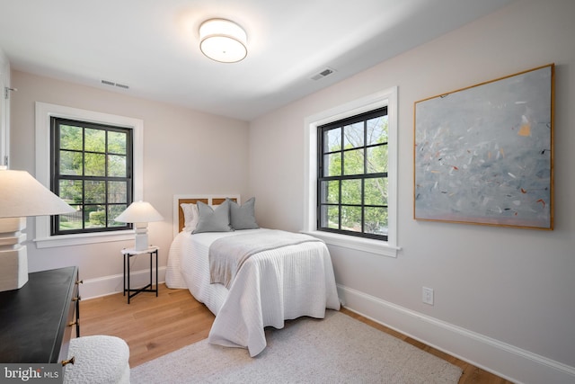 6040 Nebraska Ave NW, Washington, DC 20015 - bedroom with multiple windows, baseboards, and wood finished floors