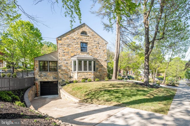 6040 Nebraska Ave NW, Washington, DC 20015 - view of front of home featuring stone siding, concrete driveway, and a garage