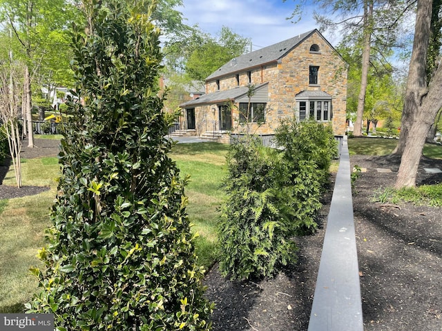 6040 Nebraska Ave NW, Washington, DC 20015 - rear view of property featuring stone siding and a yard