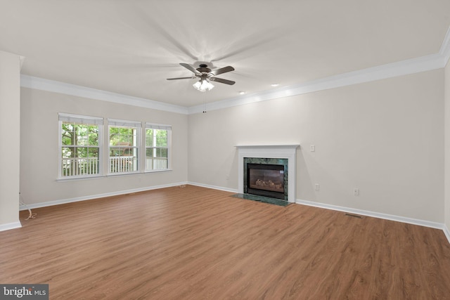 6404 Distant Melody Pl, Columbia, MD 21044 - unfurnished living room with ceiling fan, crown molding, wood finished floors, baseboards, and a high end fireplace