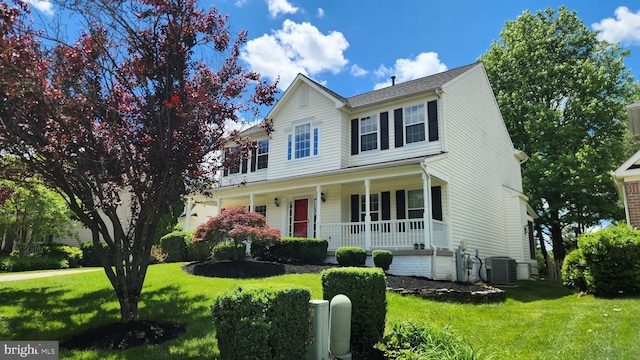 6404 Distant Melody Pl, Columbia, MD 21044 - view of front of house with a porch, central AC, and a front lawn