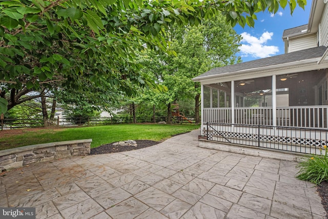 6404 Distant Melody Pl, Columbia, MD 21044 - view of patio / terrace with a sunroom, a ceiling fan, and a playground