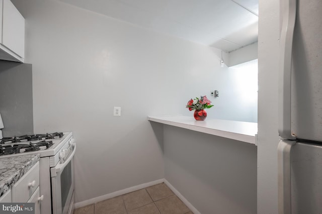 2525 Huntington Ave Unit 18, Alexandria, VA 22303 - kitchen featuring white appliances, white cabinets, light countertops, and light tile patterned floors