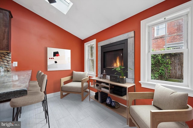 2351 E York St, Philadelphia, PA 19125 - living room featuring lofted ceiling, a skylight, and baseboards