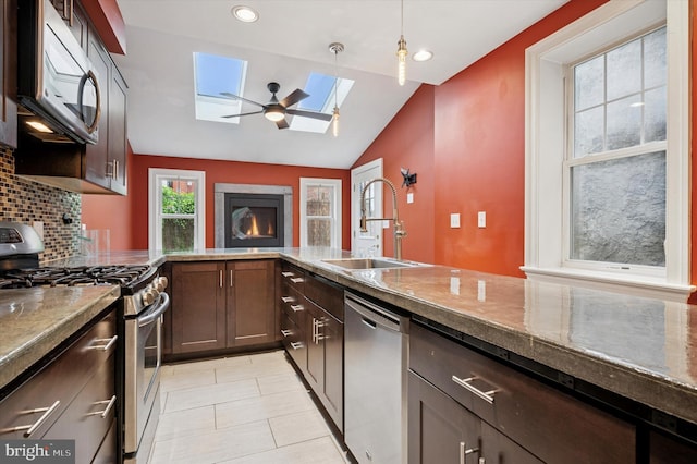 2351 E York St, Philadelphia, PA 19125 - kitchen with stainless steel appliances, a sink, a skylight, tasteful backsplash, and vaulted ceiling