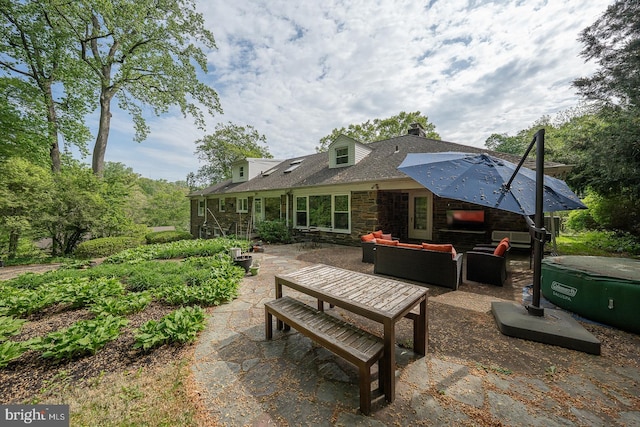 612 Manayunk Rd, Merion Station, PA 19066 - back of house with outdoor lounge area, a patio, stone siding, a chimney, and a shingled roof