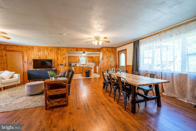 5927 Rte 6, Wellsboro, PA 16901 - dining area featuring ceiling fan, light wood-style floors, wood walls, and crown molding