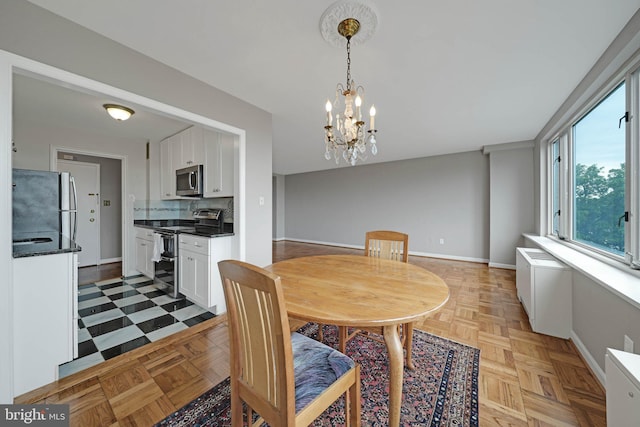 4301 Massachusetts Ave NW Unit 8009, Washington, DC 20016 - dining room featuring baseboards and a chandelier