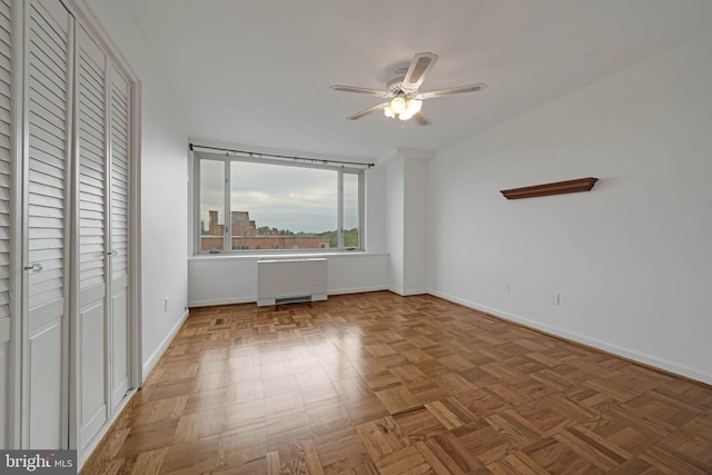 4301 Massachusetts Ave NW Unit 8009, Washington, DC 20016 - unfurnished bedroom with radiator heating unit, baseboards, and a ceiling fan