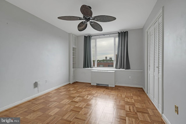 4301 Massachusetts Ave NW Unit 8009, Washington, DC 20016 - spare room featuring baseboards, a ceiling fan, and radiator heating unit
