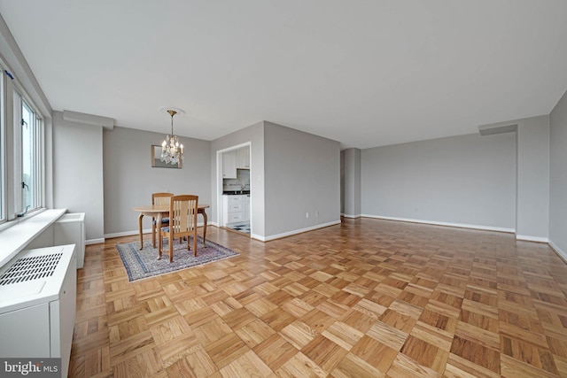 4301 Massachusetts Ave NW Unit 8009, Washington, DC 20016 - dining room featuring baseboards and a chandelier