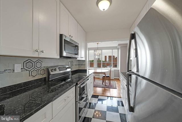 4301 Massachusetts Ave NW Unit 8009, Washington, DC 20016 - kitchen with stainless steel appliances, a chandelier, white cabinets, and tasteful backsplash