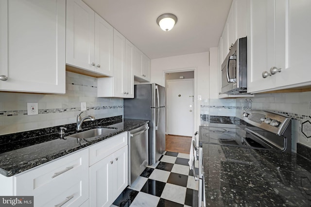 4301 Massachusetts Ave NW Unit 8009, Washington, DC 20016 - kitchen featuring a sink, stainless steel appliances, dark flooring, and white cabinets