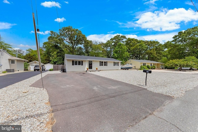 420 Conifer Dr, Forked River, NJ 08731 - ranch-style home featuring view of scattered trees, asphalt driveway, and central air condition unit