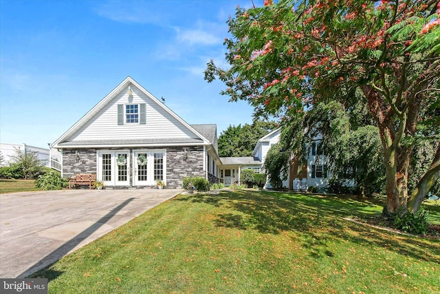 1150 S Mountain Rd, Dillsburg, PA 17019 - back of house with stone siding, a yard, and french doors