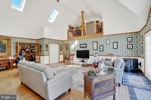 1150 S Mountain Rd, Dillsburg, PA 17019 - living area with wallpapered walls, a skylight, a wainscoted wall, high vaulted ceiling, and wood finished floors